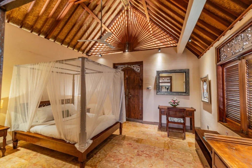 Deluxe fan room with a double bed and private balcony